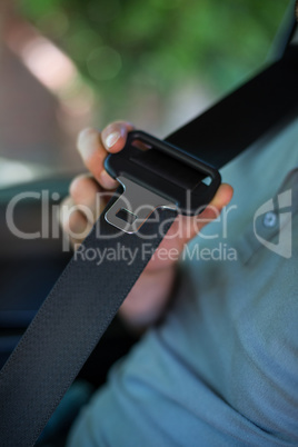 Driver holding car seat belt