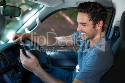 Driver using phone while sitting in car