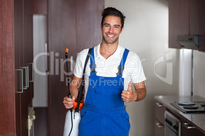Man doing pest control in kitchen