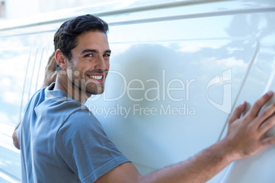 handsome man hugging car