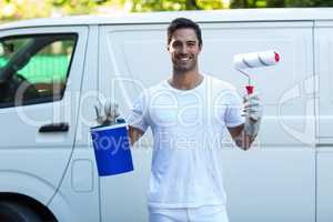 Portrait of happy painter against van