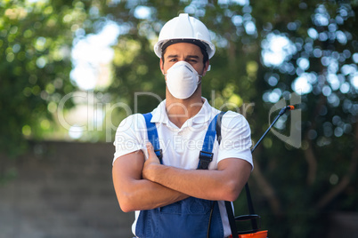 Portrait of confident pesticide worker with arms crossed
