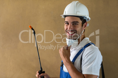 Portrait of happy manual worker with pesticide