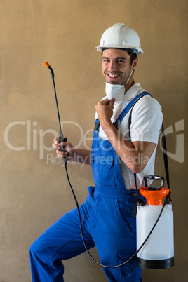 Portrait of happy manual worker with sprayer