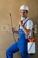 Portrait of happy manual worker with sprayer