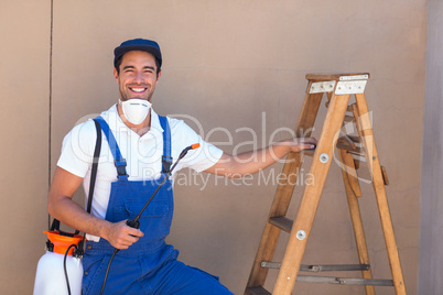 Portrait of pesticide worker standing by ladder