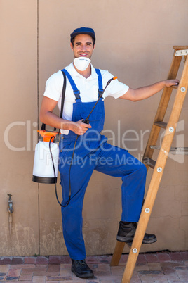 Portrait of man holding pesticide bottle