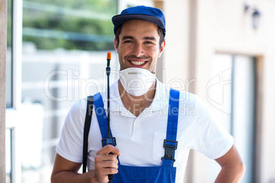 Portrait of happy worker with crop sprayer