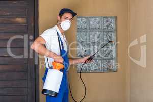 Portrait of worker spraying chemical