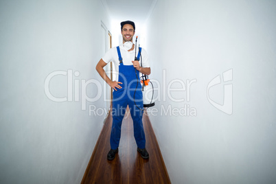 Portrait of confident pesticide worker standing in hallway