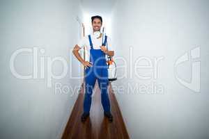 Portrait of confident pesticide worker standing in hallway