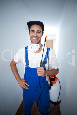 Portrait happy pest worker standing in hallway