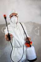Portrait of manual worker holding crop spray