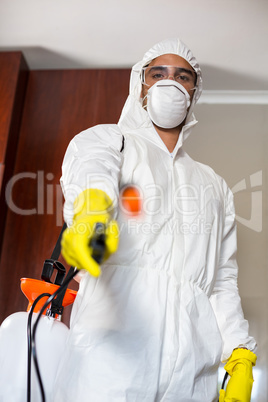 Low angle portrait of manual worker with pest sprayer