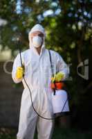 Front view of worker spraying chemical