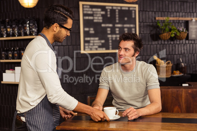 Waiter serving a coffee