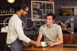 Waiter serving a coffee