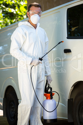 Pest control man standing next to a van