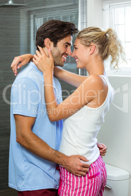 Young couple embracing in bathroom