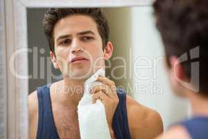Man wiping his face with napkin