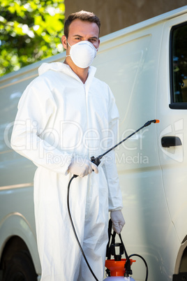 Portrait of pest control man standing next to a van