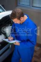 Mechanic preparing a check list
