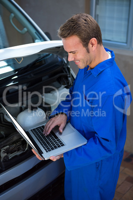 Mechanic using a laptop