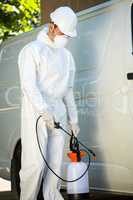 Portrait of pest control man standing next to a van