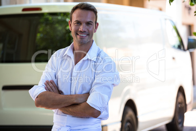 Delivery man standing in front of his van