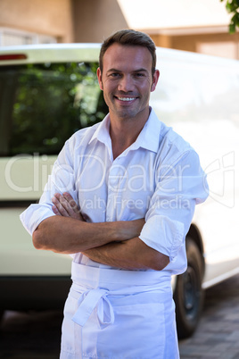 Delivery man standing in front of his van