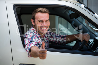 Young man showing thumbs up sign