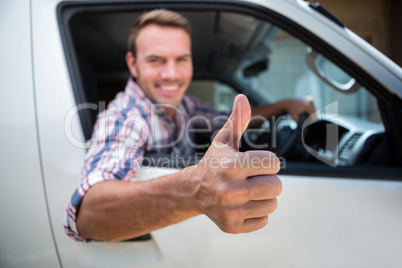 Young man showing thumbs up sign