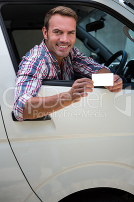 Young man showing his drivers license