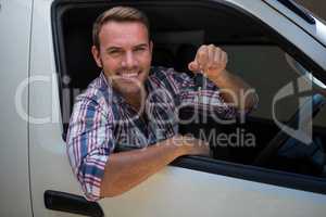 Young man showing car keys