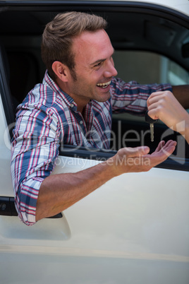 Young man receiving car keys