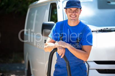 Happy janitor cleaning the car