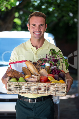 Happy man delivering groceries