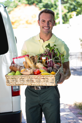 Happy man delivering groceries