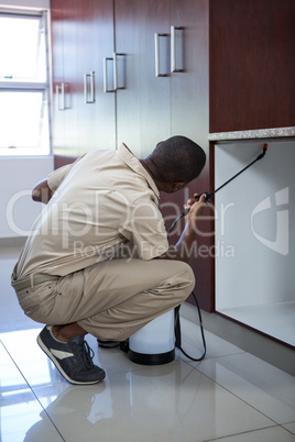 Pest control man spraying pesticide