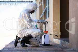 Side view of a man doing pest control