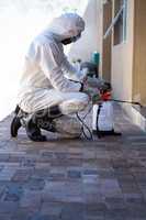Side view of a man doing pest control