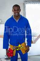 Portrait of handy man wearing tool belt