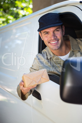 Smiling delivery man sitting in his van