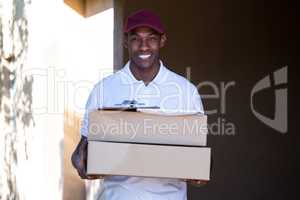 Happy delivery man holding a parcel
