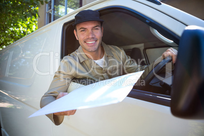 Smiling delivery man sitting in his van