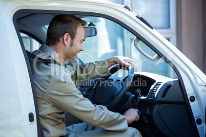 Delivery man starting a car