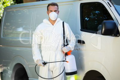 Portrait of pest control man standing next to a van