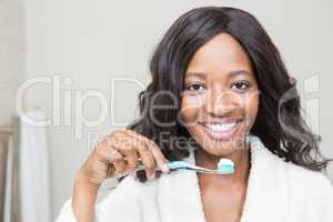 Portrait of a young woman holding tooth brush