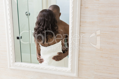 Reflection of young couple standing face to face