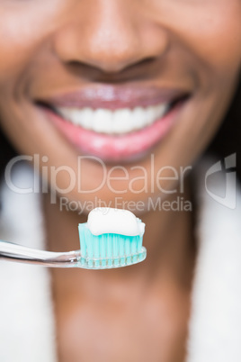 Close-up of a young woman brushing her teeth